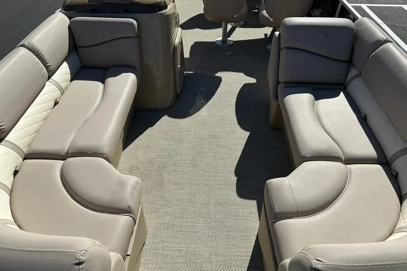 Slide: The Image of 2014 Bennington 24 SPDX pontoon boat interior with beige seating and carpeted floor. - 7