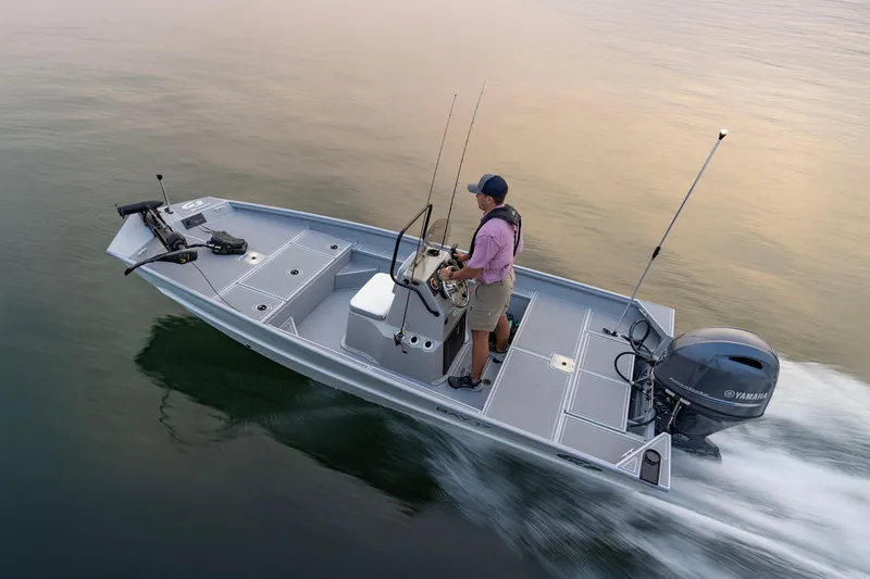 Slide: The Image of Man steering 2026 G3 Bay 17 boat on calm water, equipped with Yamaha motor. - 27