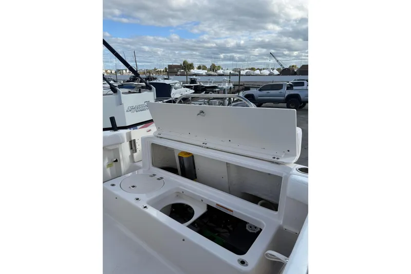 Slide: The Image of 2018 Robalo R222 Explorer boat storage compartment open, showcasing interior features. - 3