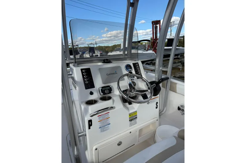 Slide: The Image of 2018 Robalo R222 Explorer boat console with Garmin navigation system and steering wheel. - 5