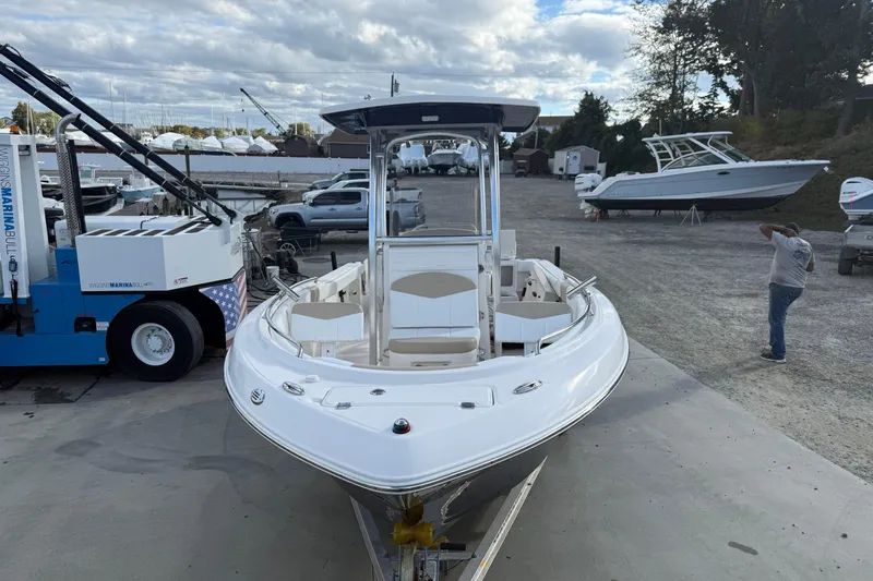 Slide: The Image of 2018 Robalo R222 Explorer boat on trailer at marina, cloudy sky background. - 6