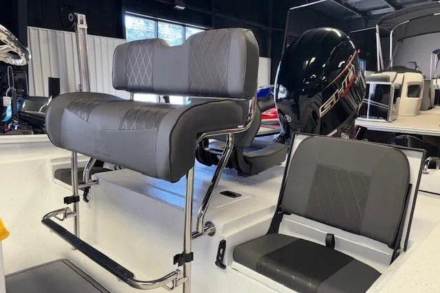 Slide: The Image of 2026 Xpress H22B Bay boat interior with modern seating and powerful engine. - 11
