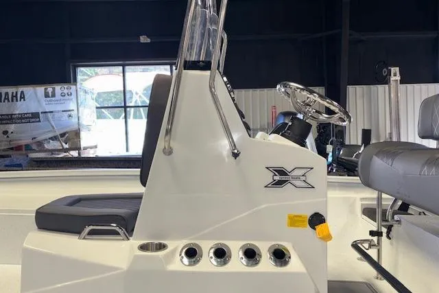 Slide: The Image of 2026 Xpress H22B Bay boat interior with steering console and seating. - 12
