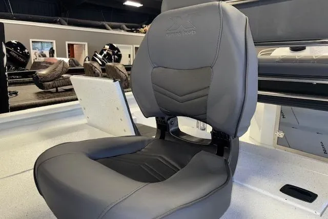 Slide: The Image of 2026 Xpress H22B Bay boat seat in a showroom, featuring sleek gray upholstery. - 15