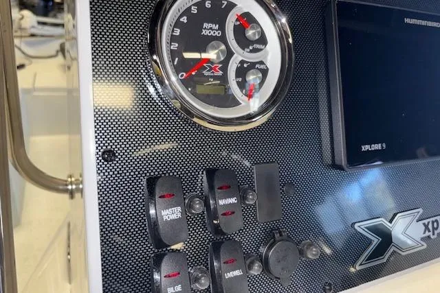 Slide: The Image of Dashboard of 2026 Xpress H22B Bay boat with gauges and control switches. - 16