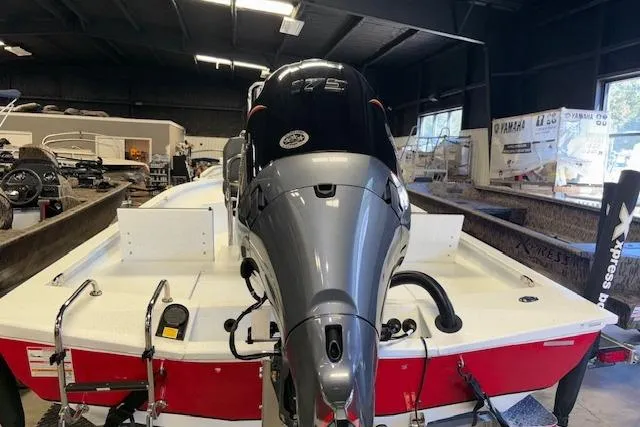 Slide: The Image of 2026 Xpress H22B Bay boat with powerful outboard motor in showroom. - 7