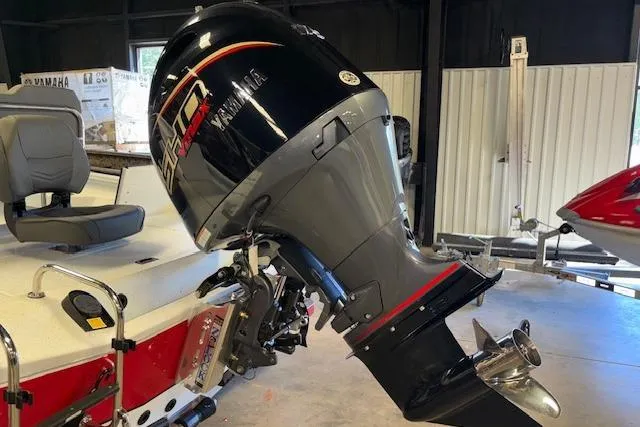 Slide: The Image of 2026 Xpress H22B Bay boat with Yamaha outboard motor in a showroom. - 8