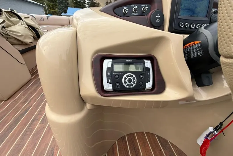 Slide: The Image of Control panel of a 2016 Berkshire 230CL STS boat with Clarion audio system. - 11