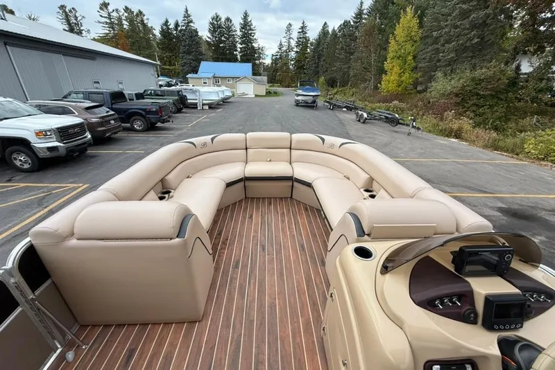 Slide: The Image of 2016 Berkshire 230CL STS pontoon boat with beige seating and wood-style flooring. - 13
