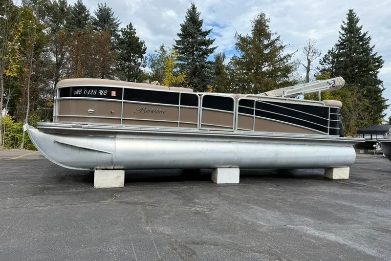 Slide: The Image of 2016 Berkshire 230CL STS pontoon boat on blocks, surrounded by trees. - 2