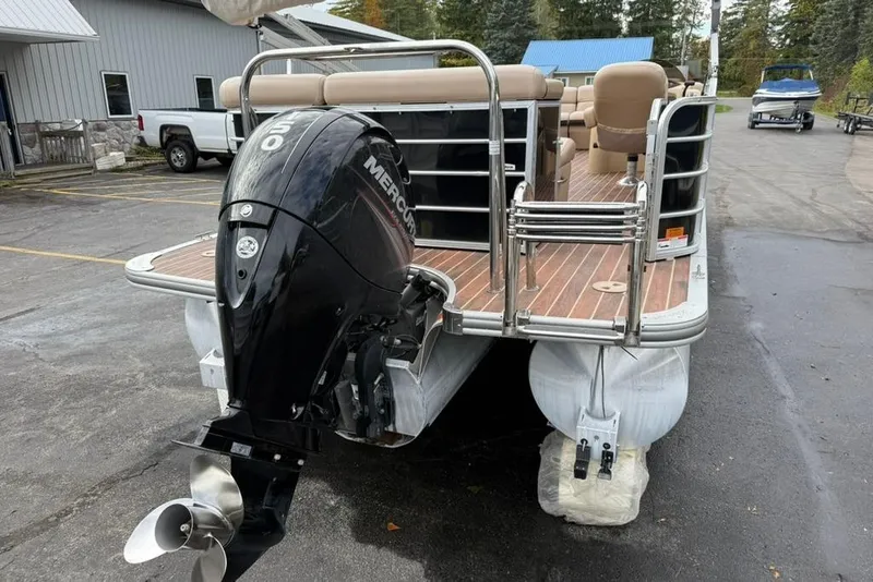 Slide: The Image of 2016 Berkshire 230CL STS pontoon boat with Mercury outboard motor, parked outdoors. - 5