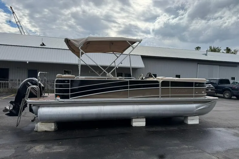 Slide: The Image of 2016 Berkshire 230CL STS pontoon boat with canopy, parked outside a building. - 6