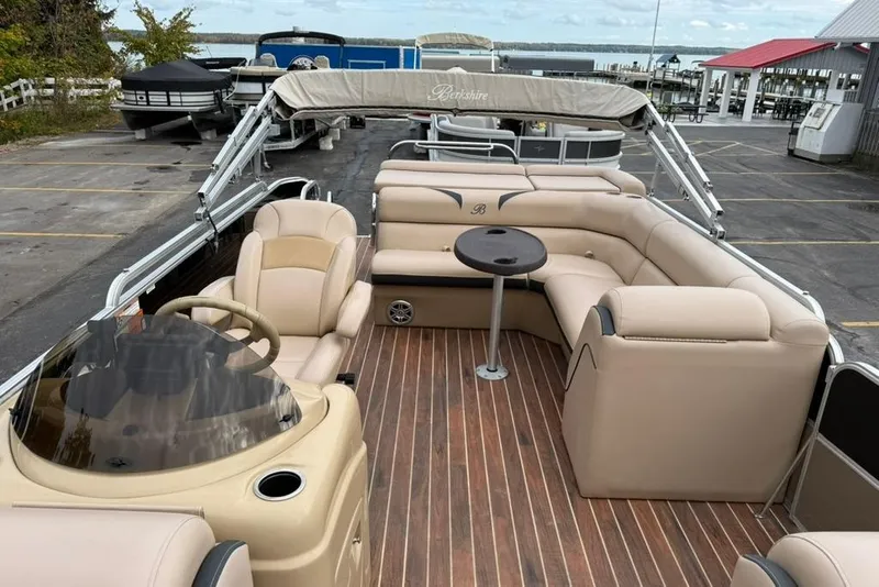 Slide: The Image of 2016 Berkshire 230CL STS pontoon boat with beige seating and wood-style flooring. - 8
