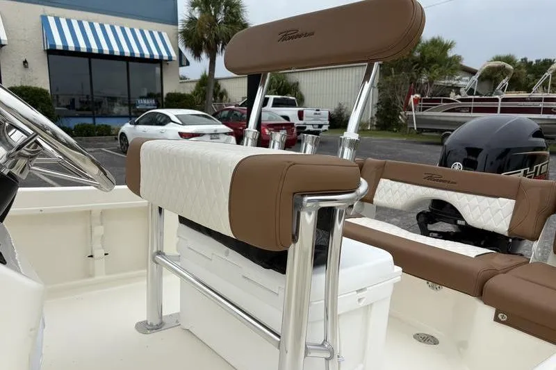 Slide: The Image of 2026 Pioneer Islander 180 boat interior with brown and white seating, chrome accents. - 11