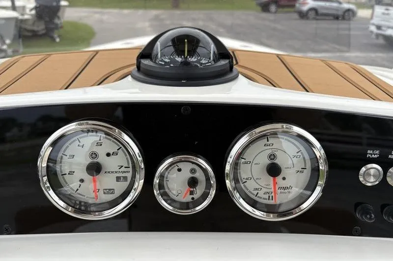 Slide: The Image of Dashboard of 2026 Pioneer Islander 180 boat with gauges and compass. - 16