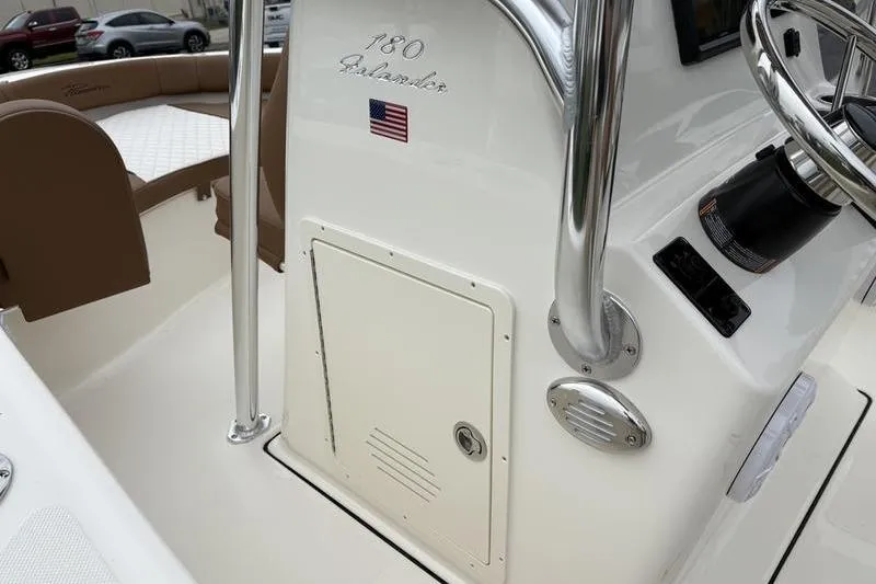 Slide: The Image of 2026 Pioneer Islander 180 boat interior with steering console and seating area. - 20