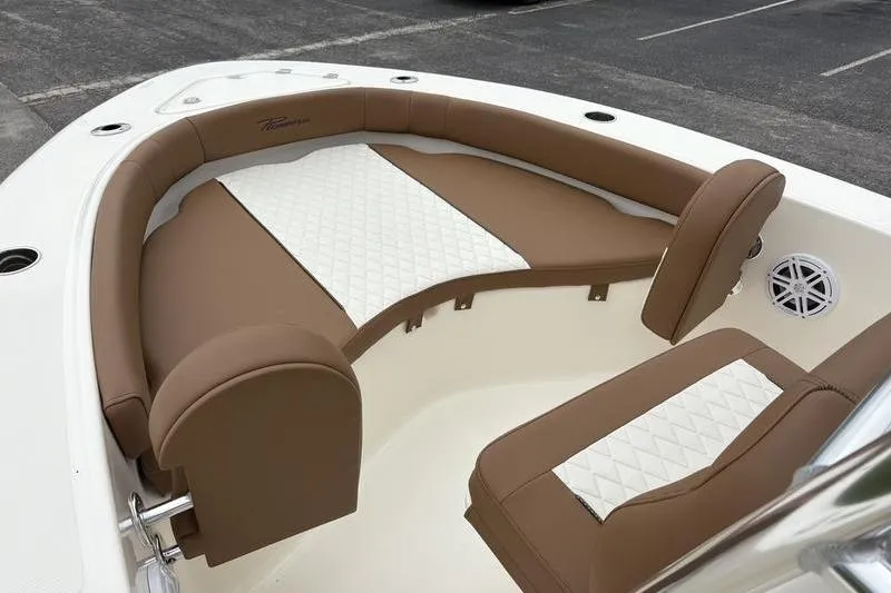 Slide: The Image of 2026 Pioneer Islander 180 boat interior with brown and white cushioned seating. - 23