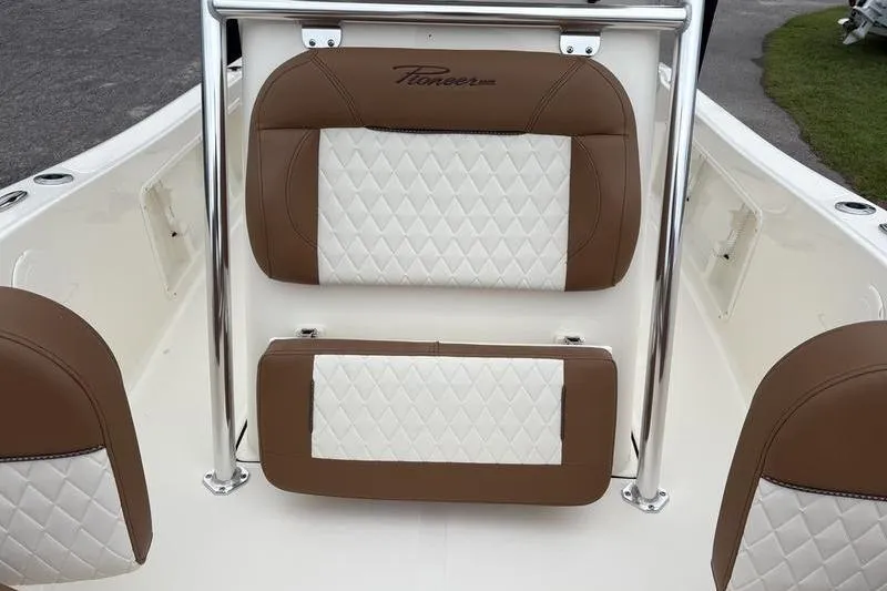 Slide: The Image of 2026 Pioneer Islander 180 boat interior with brown and white quilted seats. - 25