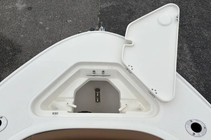 Slide: The Image of 2026 Pioneer Islander 180 boat storage compartment with open hatch on deck. - 26