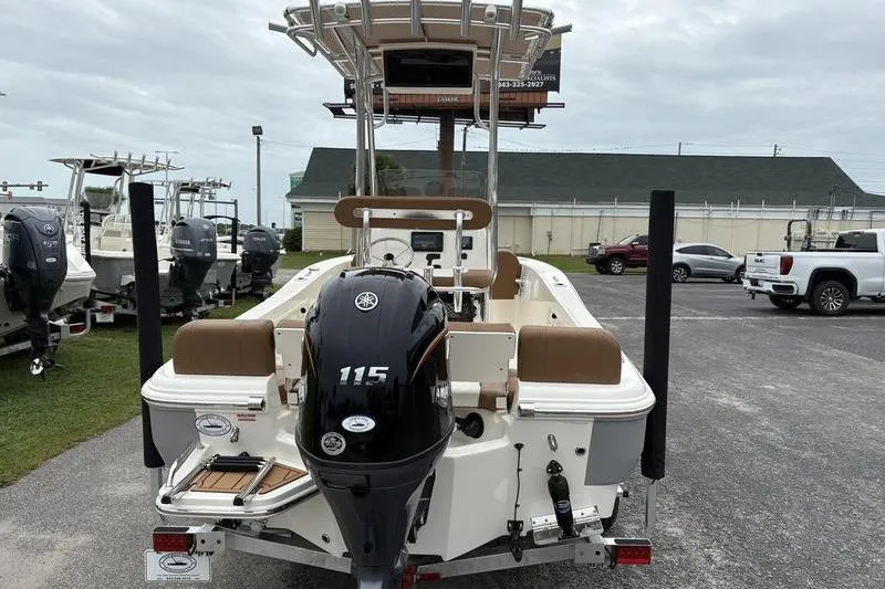 Slide: The Image of 2026 Pioneer Islander 180 boat with Yamaha 115 outboard motor, parked outdoors. - 3