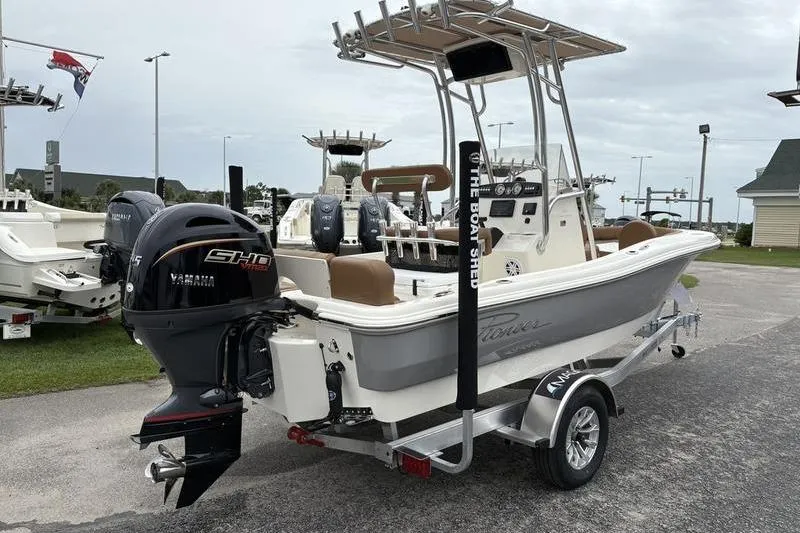 Slide: The Image of 2026 Pioneer Islander 180 boat with Yamaha engine on trailer, outdoor display. - 4