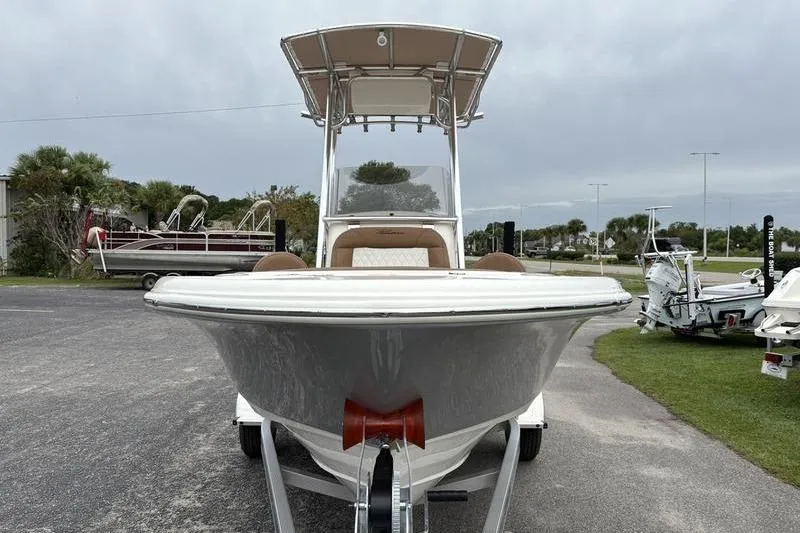 Slide: The Image of 2026 Pioneer Islander 180 boat on trailer, front view, parked outdoors. - 7