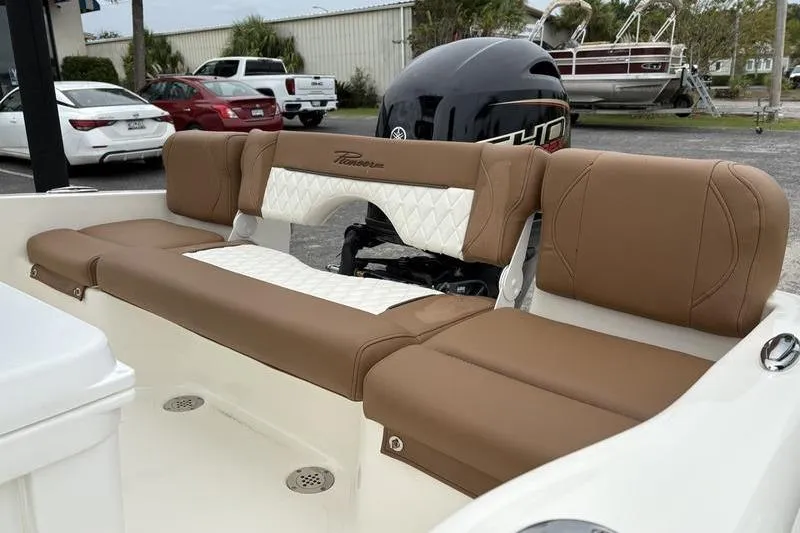 Slide: The Image of 2026 Pioneer Islander 180 boat interior with tan and white cushioned seating. - 9