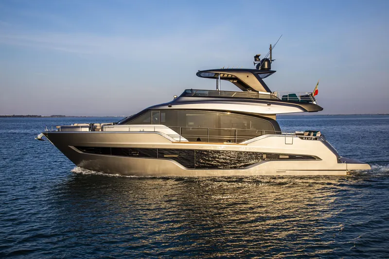 The Image of Luxury 2026 Cranchi Sessantasette 67 yacht cruising on open water at sunset. - 1