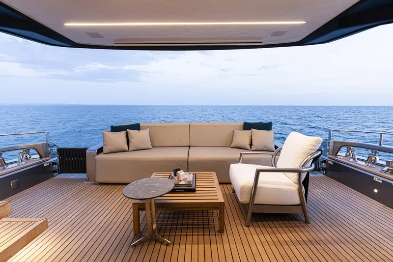 Slide: The Image of Luxurious 2026 Cranchi Sessantasette 67 yacht deck with elegant seating and ocean view. - 11