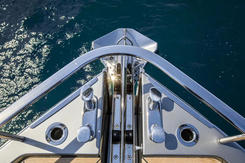 Slide: The Image of Bow of 2026 Cranchi Sessantasette 67 yacht with polished metal details and ocean view. - 25
