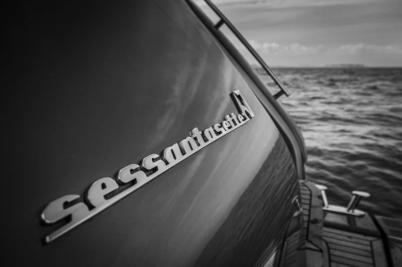 Slide: The Image of 2026 Cranchi Sessantasette 67 yacht, sleek design, ocean backdrop, monochrome. - 27