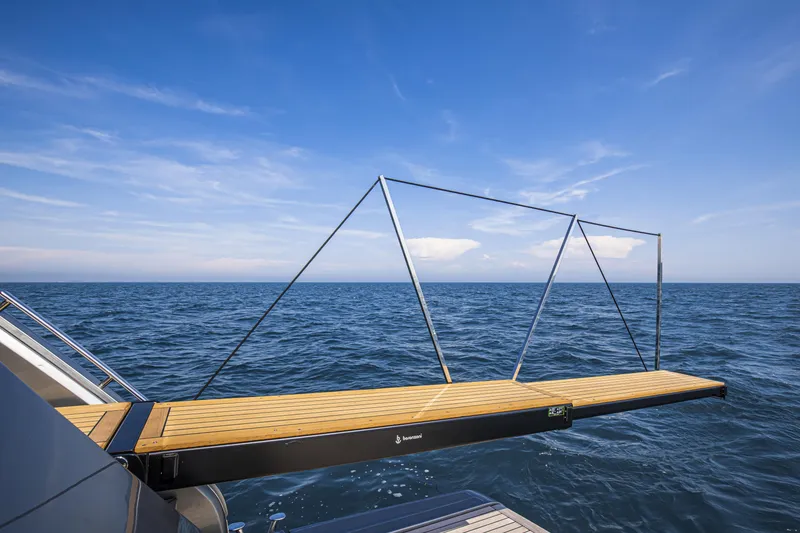 Slide: The Image of Luxury yacht Cranchi Sessantasette 67, 2026, with extended gangway over ocean. - 28