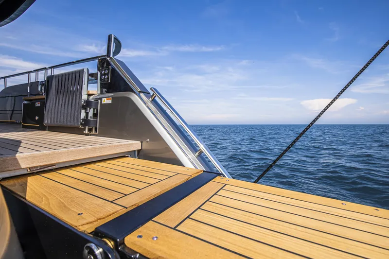 Slide: The Image of 2026 Cranchi Sessantasette 67 yacht deck overlooking the ocean under a clear blue sky. - 29