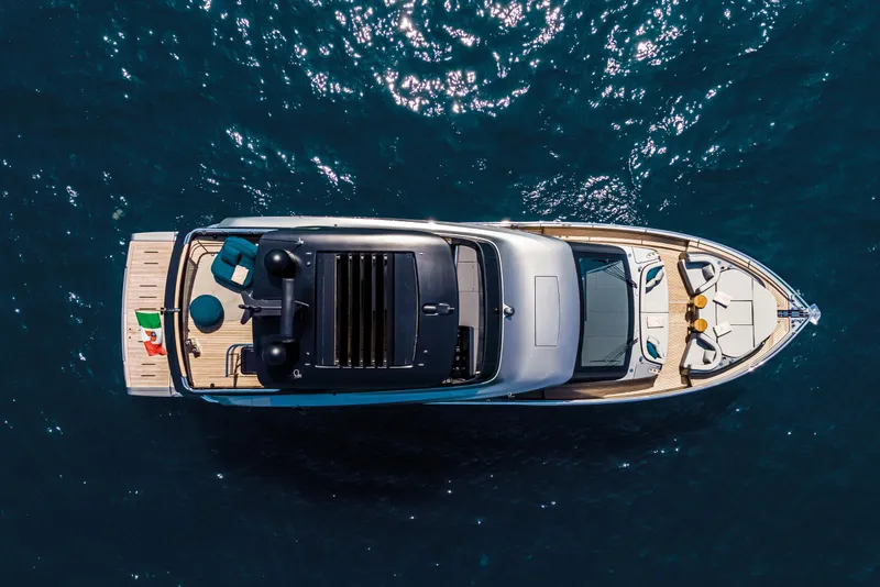 Slide: The Image of Aerial view of 2026 Cranchi Sessantasette 67 yacht on blue ocean water. - 6