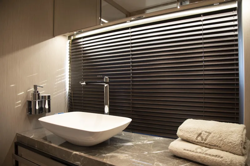 Slide: The Image of Luxurious bathroom interior of 2026 Cranchi Sessantasette 67 yacht with modern sink and towels. - 63