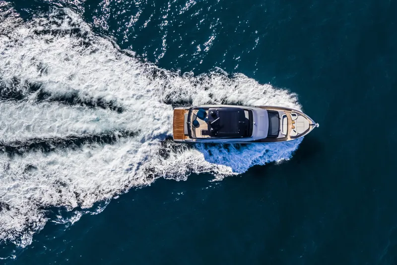 Slide: The Image of Aerial view of 2026 Cranchi Sessantasette 67 yacht cruising on open water. - 9