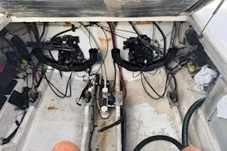 Slide: The Image of 2007 Sea Ray 290 Amberjack boat interior with white seating and blue canopy. - 10