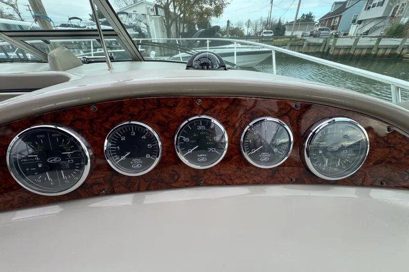 Slide: The Image of Dashboard of 2007 Sea Ray 290 Amberjack boat with gauges and wood paneling. - 15