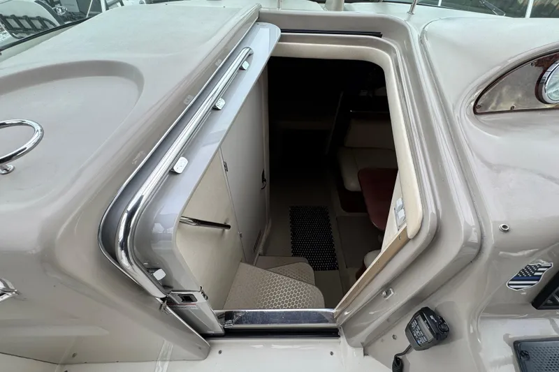 Slide: The Image of 2007 Sea Ray 290 Amberjack cabin entrance with sleek chrome details and interior view. - 21