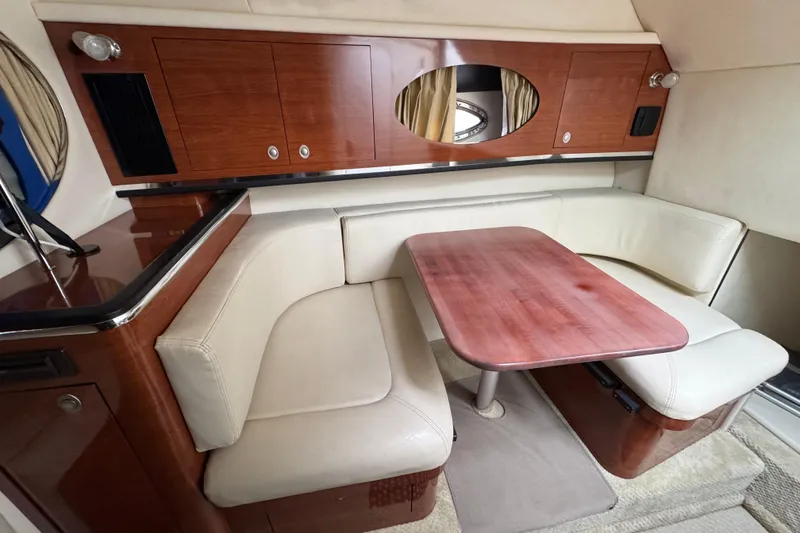 Slide: The Image of Interior of 2007 Sea Ray 290 Amberjack with cozy seating and wooden table. - 30