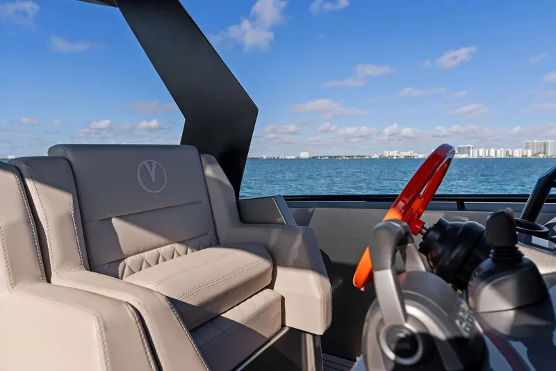 Slide: The Image of Vanquish Yachts VQ40 2022 interior with luxury seating and steering, ocean view. - 24