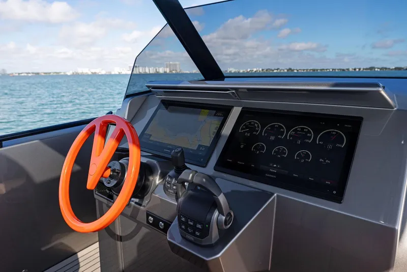 Slide: The Image of 2022 Vanquish Yachts VQ40 dashboard with orange steering wheel and digital displays. - 42