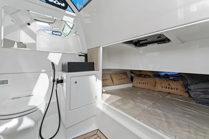 Slide: The Image of Luxurious interior of 2022 Vanquish Yachts VQ40, featuring modern bathroom and storage space. - 46