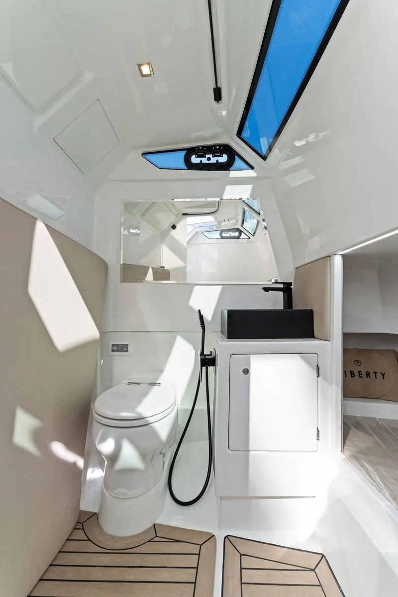 Slide: The Image of Luxurious 2022 Vanquish Yachts VQ40 bathroom with modern fixtures and skylight. - 49