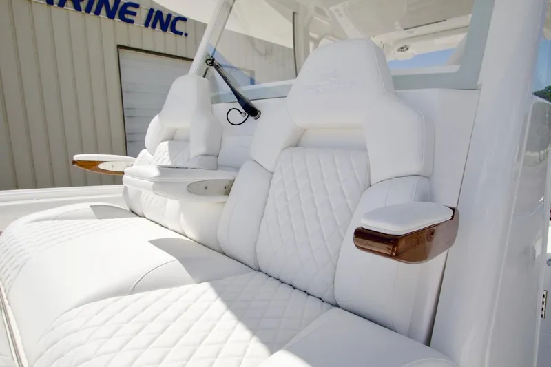 Slide: The Image of Luxurious white seating on 2026 Regulator 37 boat with elegant design and wooden armrests. - 12