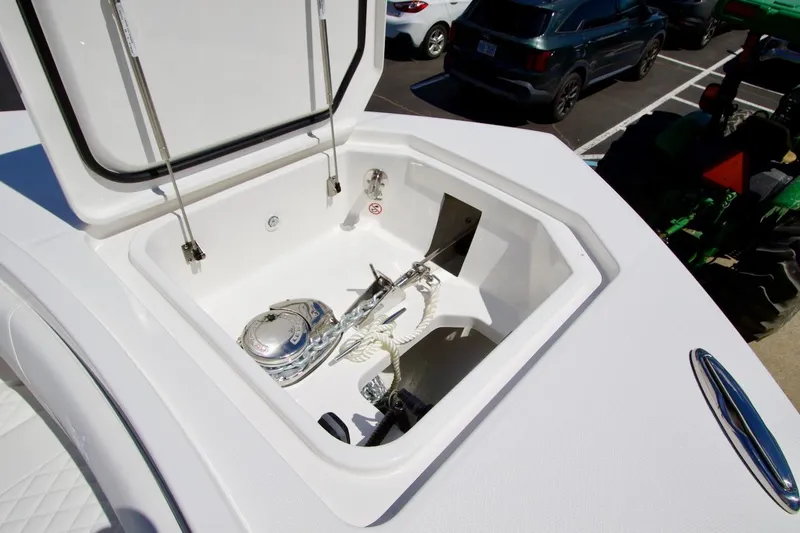 Slide: The Image of Open storage compartment on 2026 Regulator 37 boat, featuring anchor and rope. - 13