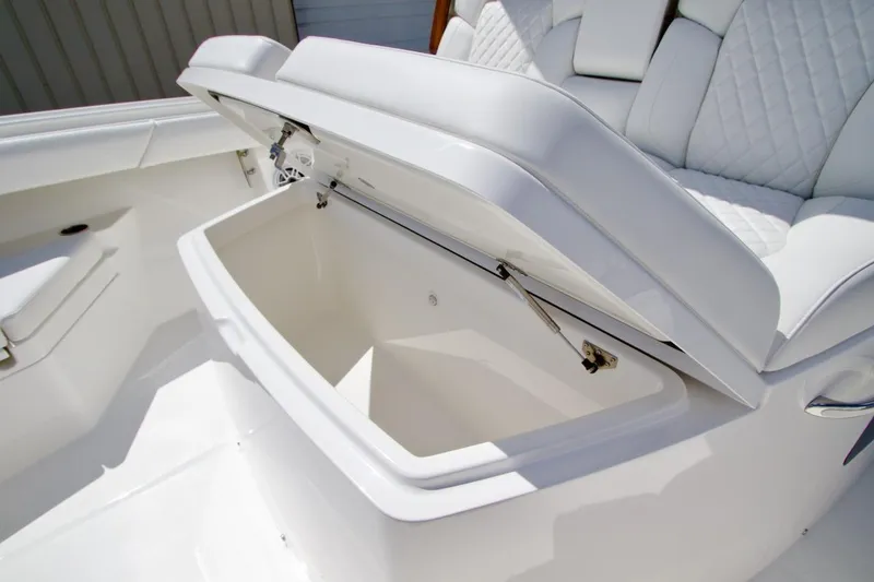 Slide: The Image of 2026 Regulator 37 boat with open storage compartment and cushioned seating. - 14