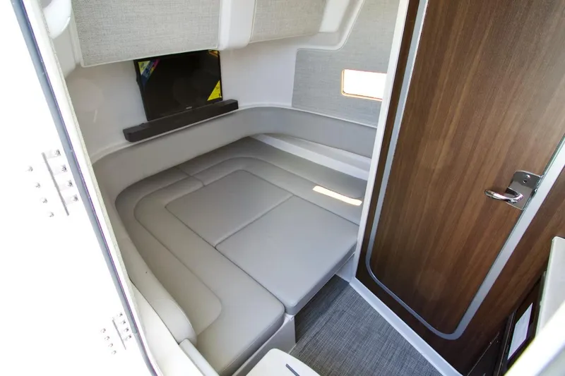 Slide: The Image of 2026 Regulator 37 cabin interior with cushioned seating and wooden door. - 15