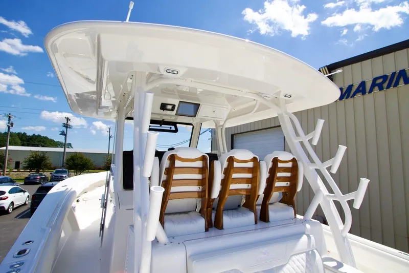 Slide: The Image of 2026 Regulator 37 boat with seating and rod holders under a clear blue sky. - 21