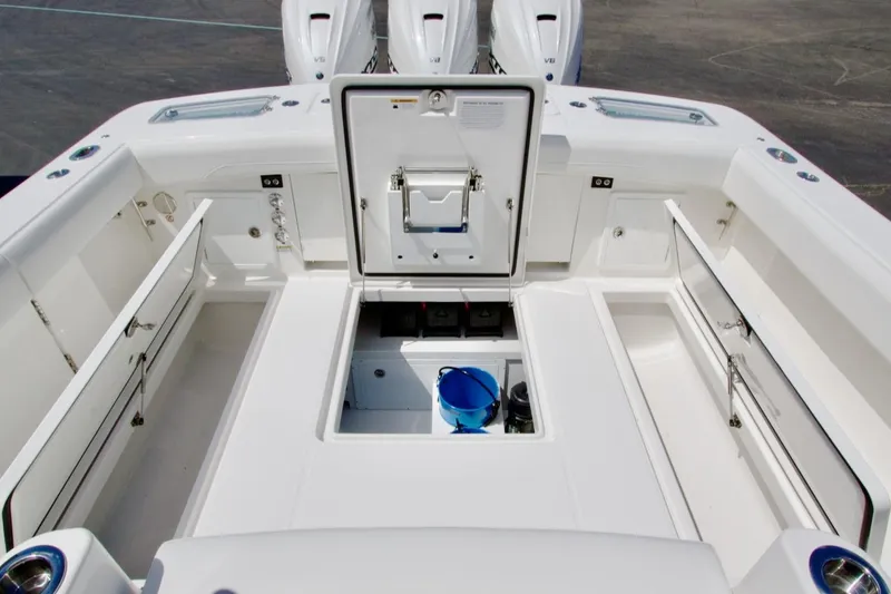 Slide: The Image of 2026 Regulator 37 boat interior with open storage compartments and engine access. - 5